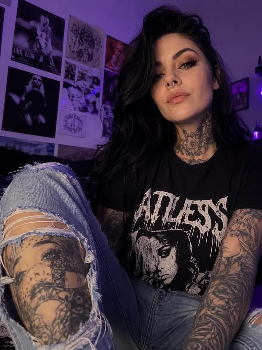 Tattooed goth OnlyFans creator posing against a dark backdrop for Bunny Agency